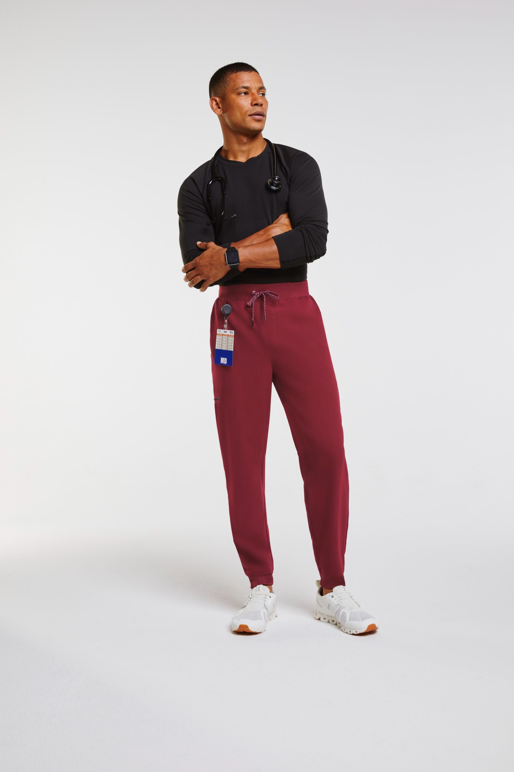 man in burgundy jogger scrubs