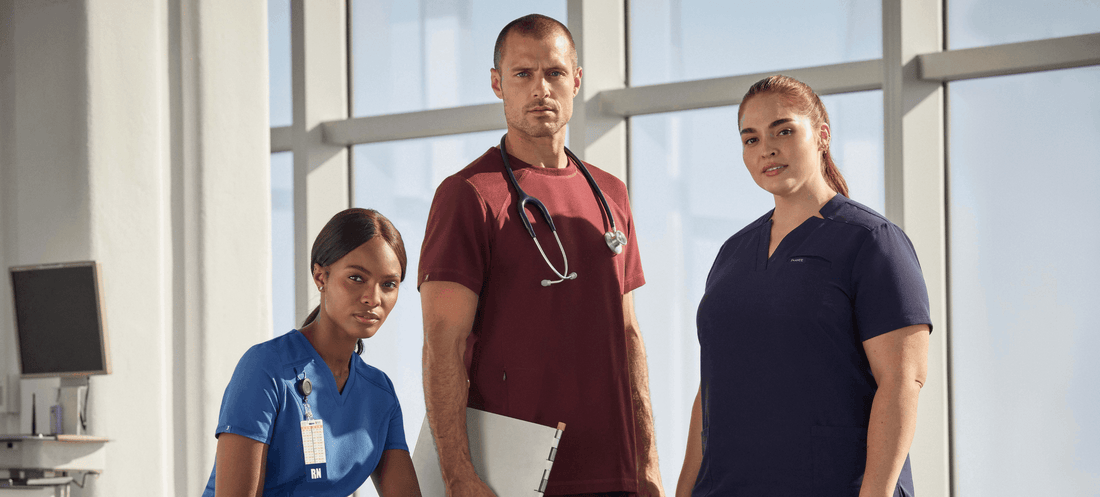 Man-between-two-women-wearing-different-color-scrubs.png