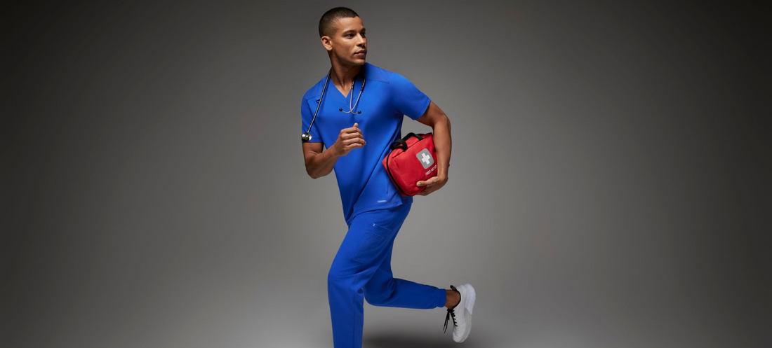 Man-wearing-blue-scrubs-carrying-first-aid-kit.png