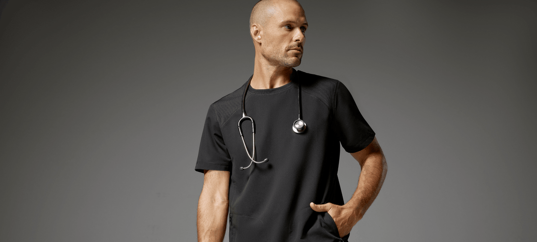 Man-wearing-raglan-sleeve-top-scrubs-in-black.png