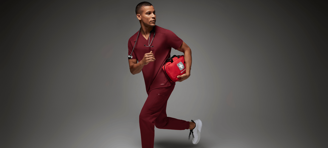 Man-with-red-scrubs-and-first-aid-kit-1.png