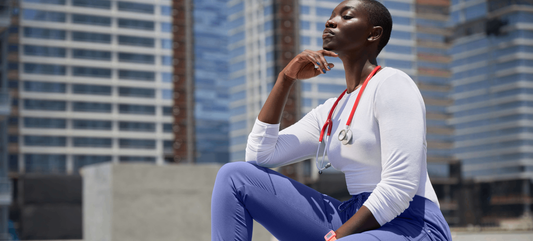 nurse-wearing-blue-joggers-and-white-blouse.png