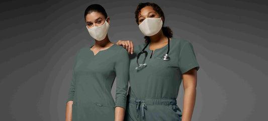 nurses-wearing-masks-in-front-of-grey-background-scaled.jpg