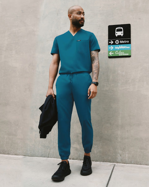 Healthcare worker wearing Caribbean Blue scrubs.