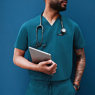 Healthcare worker wearing Caribbean Blue scrubs.