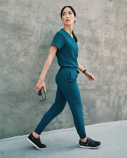 Healthcare worker wearing Caribbean Blue scrubs.