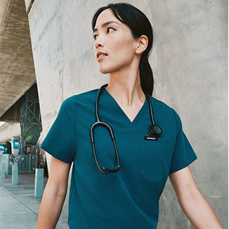 Healthcare worker wearing Caribbean Blue scrubs.